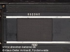 This camera features a special serial number engraving, where the usual prefixed framed VX is engraved below the lower film guide.