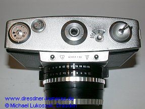 Pentina M (camera underside with controls such as rewind crank, film reminder dial, counter)