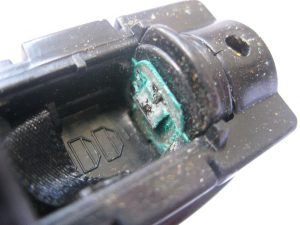 Battery corrosion may be greenish or white in color.
